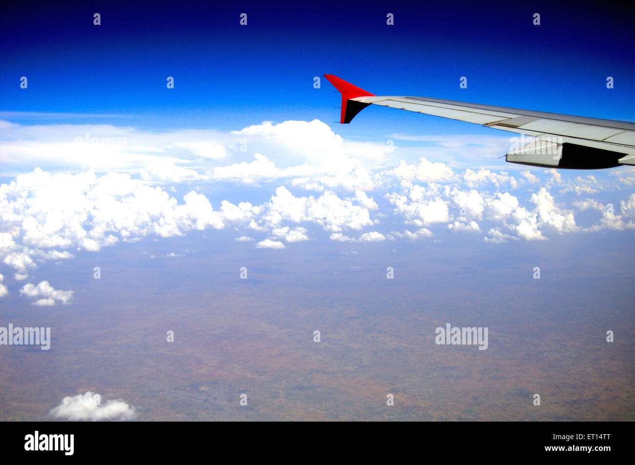 Aeroplane wing aerial on blue sky Stock Photo