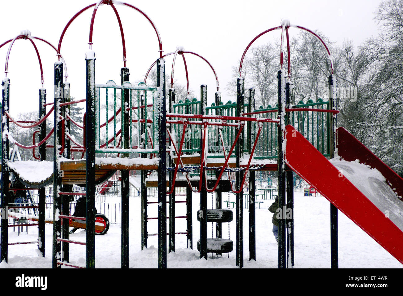 Snowstorm covering playground in park ; London ; UK United Kingdom England Stock Photo