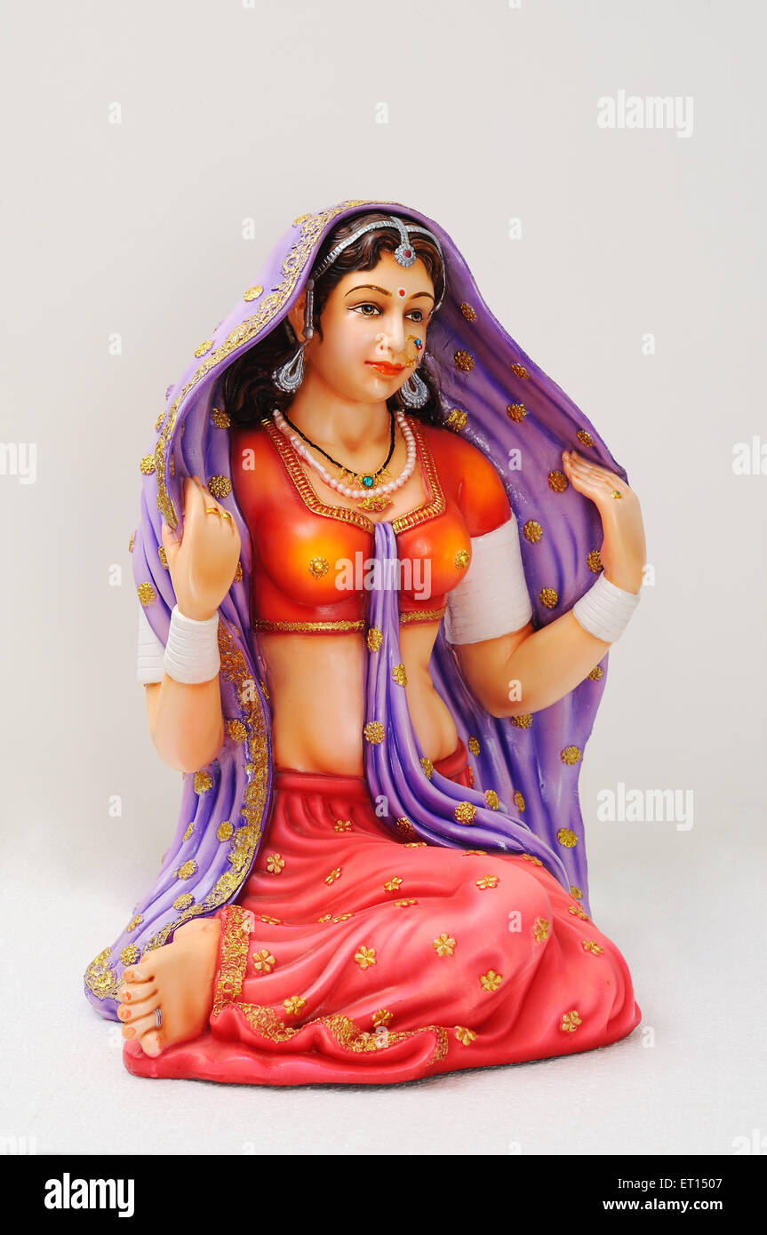 Clay figurine ; statue of rajasthani girl wearing jewellery and pallu on her head Stock Photo