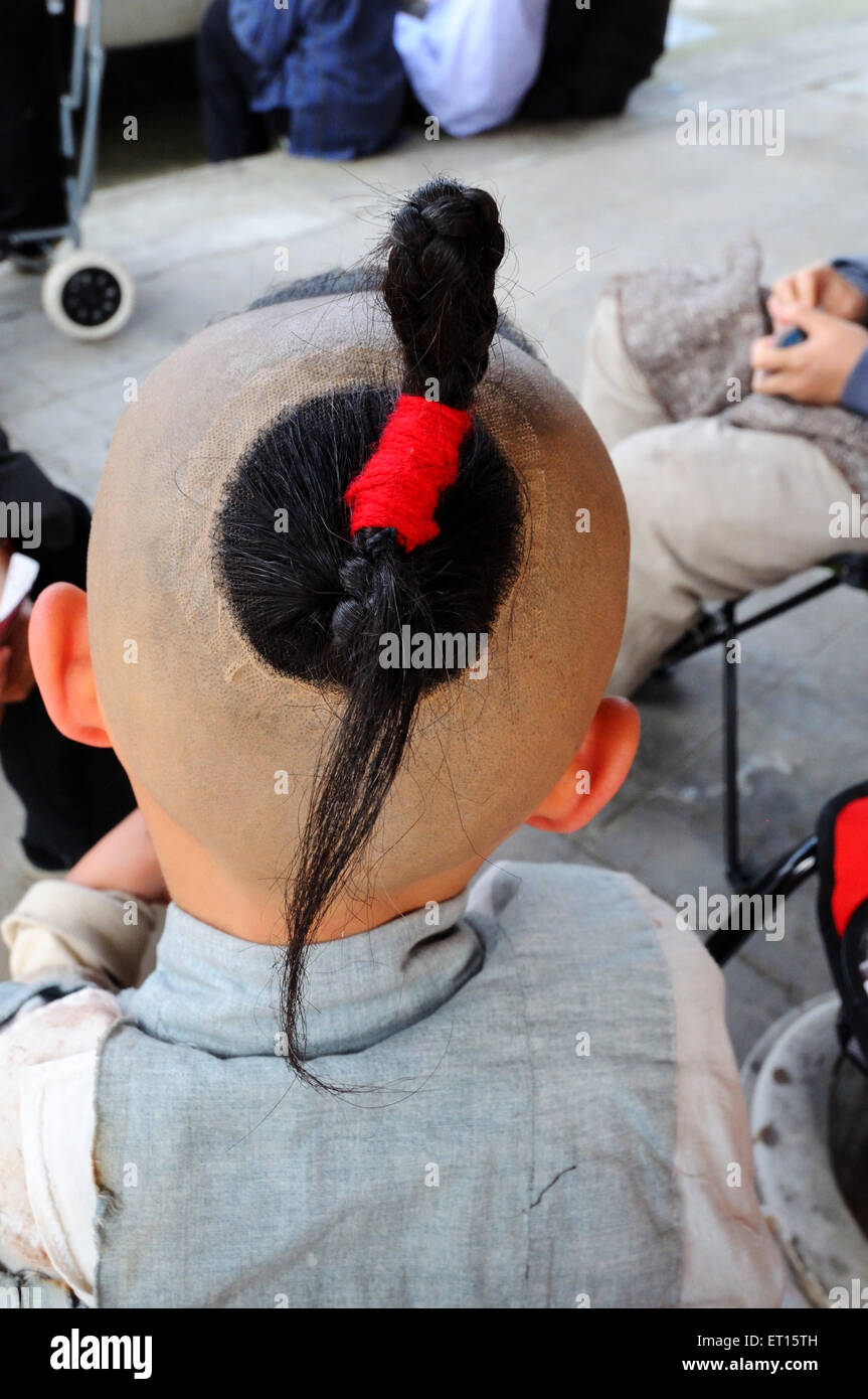 Chinese boy with bald head, hair style, red ribbon, Dong Yang, Dongyang, Jinhua, Zhejiang, China, Chinese Stock Photo