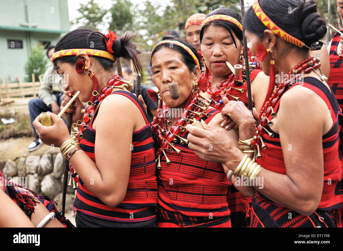 Naga tribe women smoking pipe ; Kohima ; Kisama village ; Nagaland ; North East ; India NOMR Stock Photo