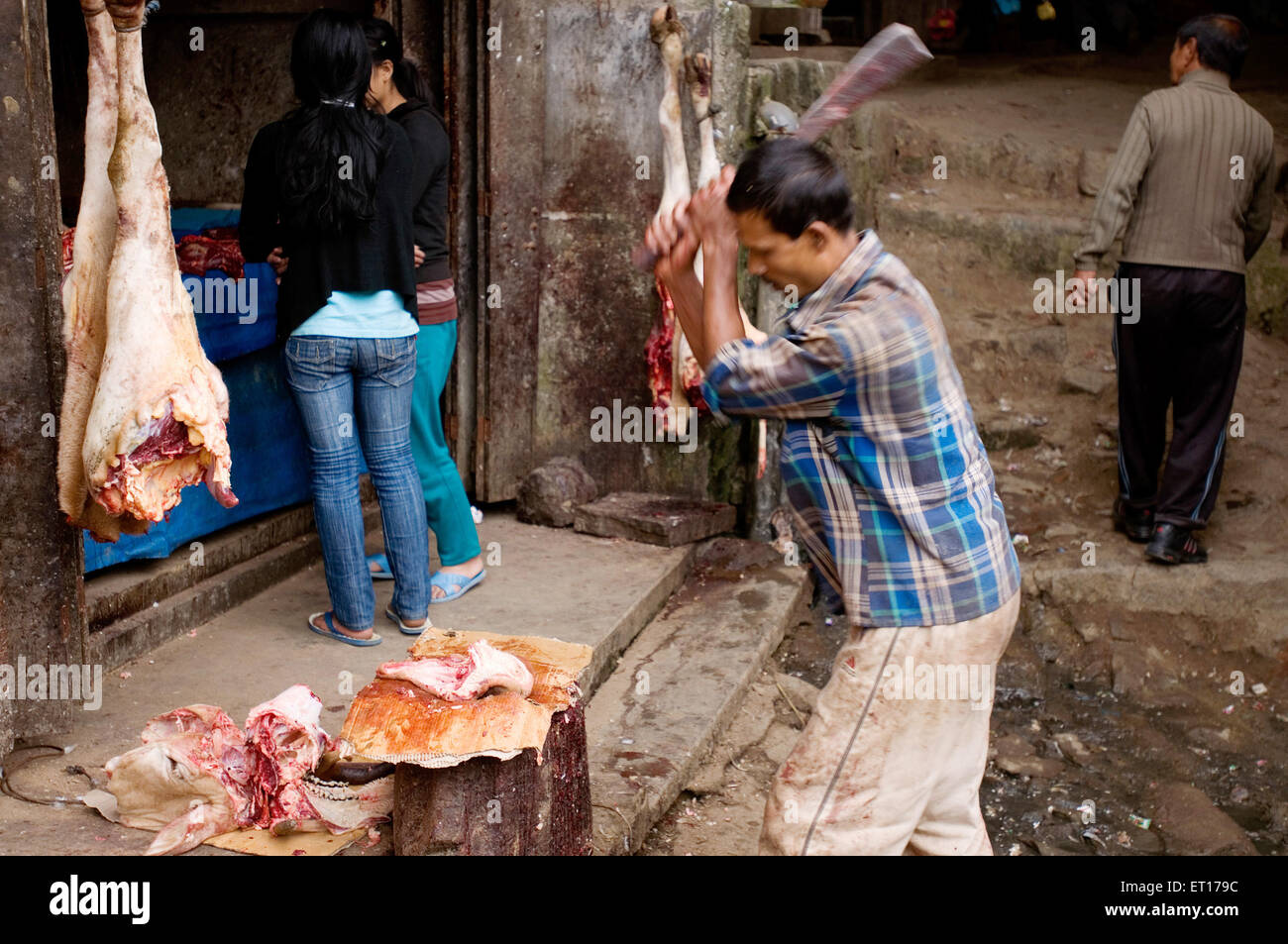 Butcher chopping meat ; Kohima ; Nagaland ; North East ; India NOMR Stock Photo