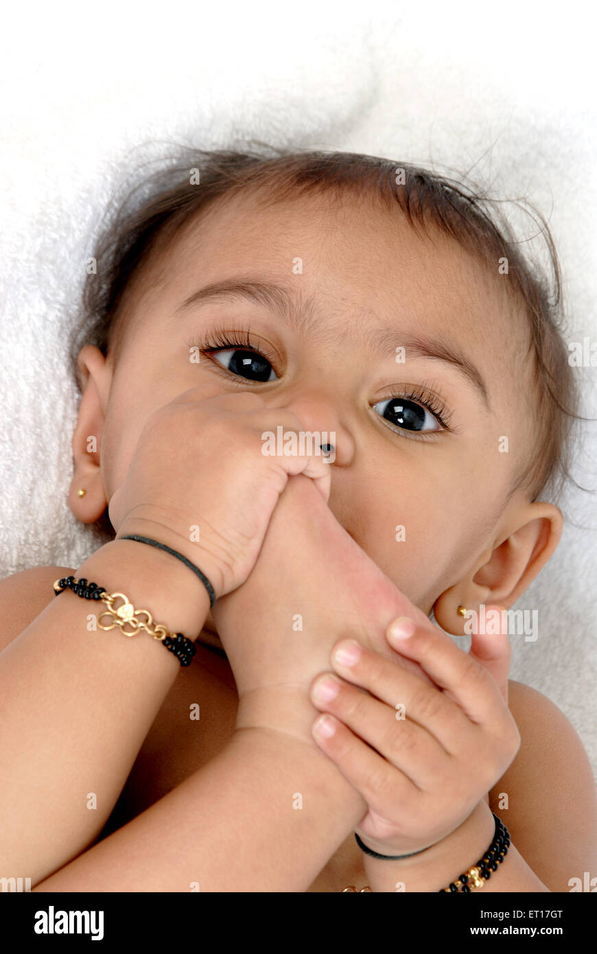 Baby boy sucking his toes ; Bombay Mumbai ; Maharashtra ; India MR#152 Stock Photo
