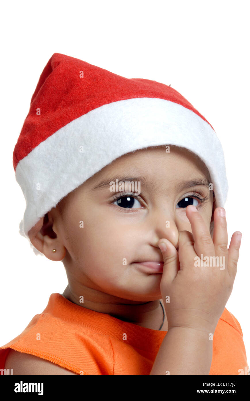 Baby boy santa claus cap holding pressing nose - MR#152 Stock Photo