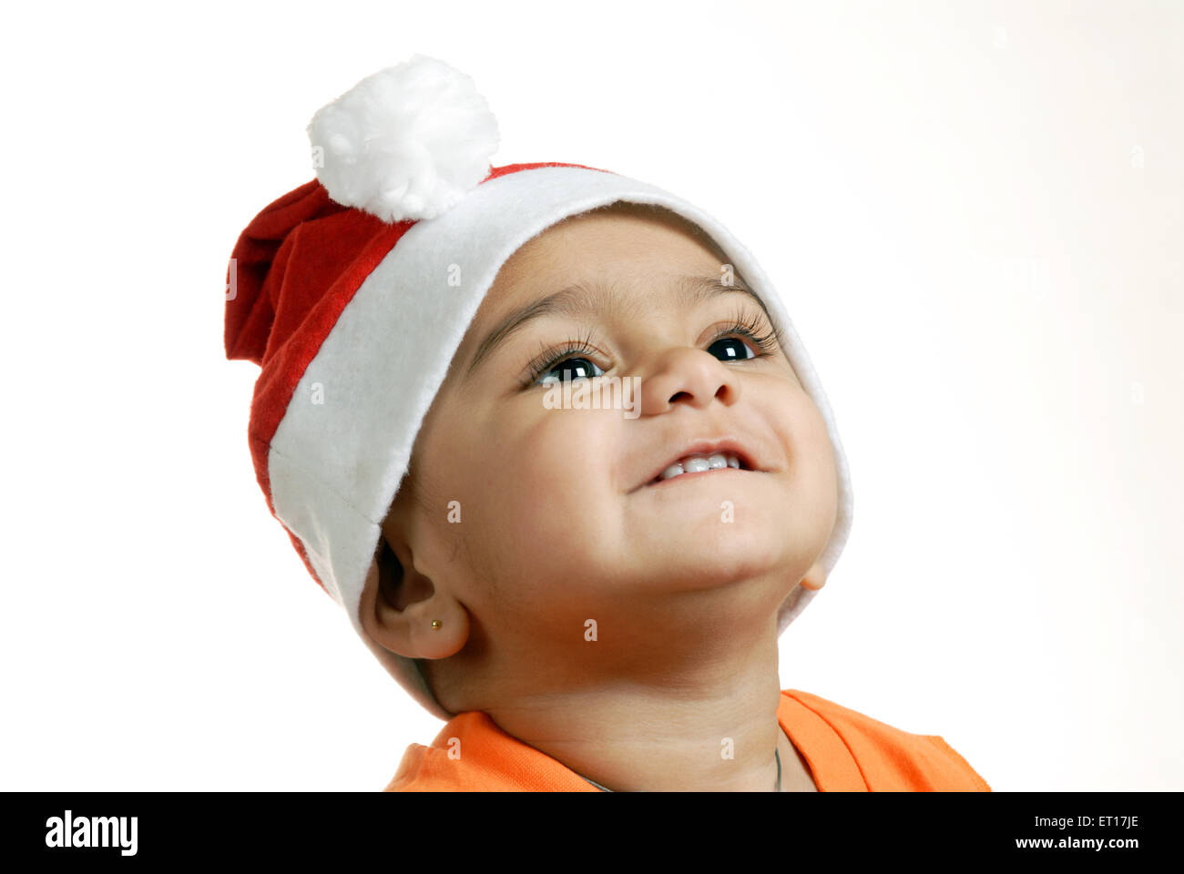 Indian child baby boy Christmas party Santa Claus cap looking up - MR#152 - RMM 150216 Stock Photo