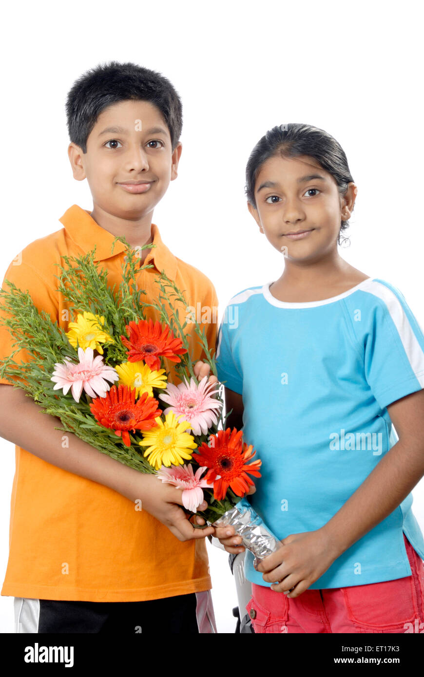 Brother and sister holding flower bouquet and celebrating birthday