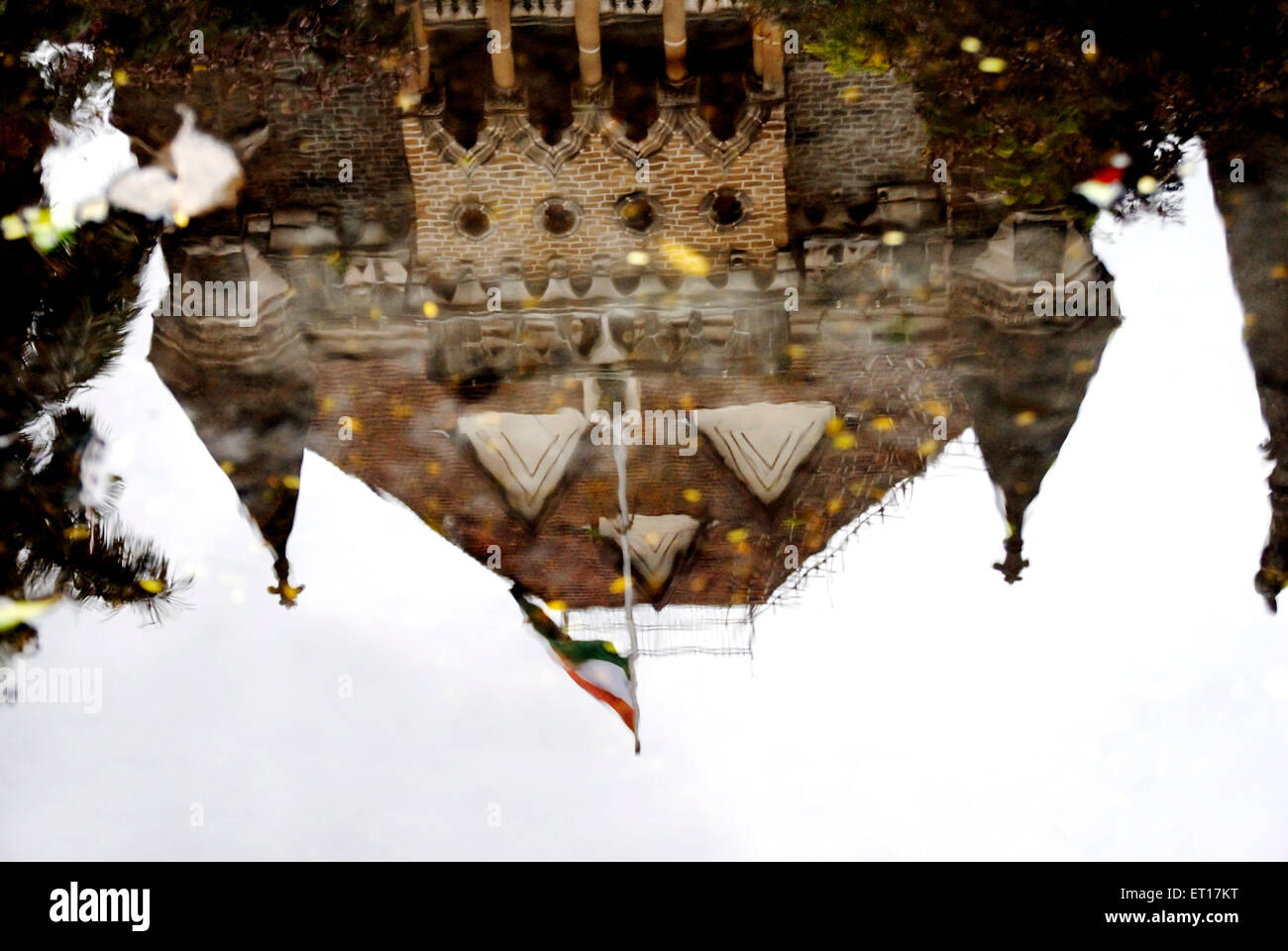 Reflection of high court in water with coconut tree and flag; Bombay Mumbai ; Maharashtra ; India Stock Photo