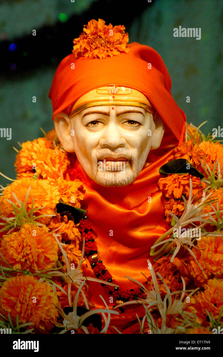God saint idol of Sai Baba with orange shawl and turban Stock Photo