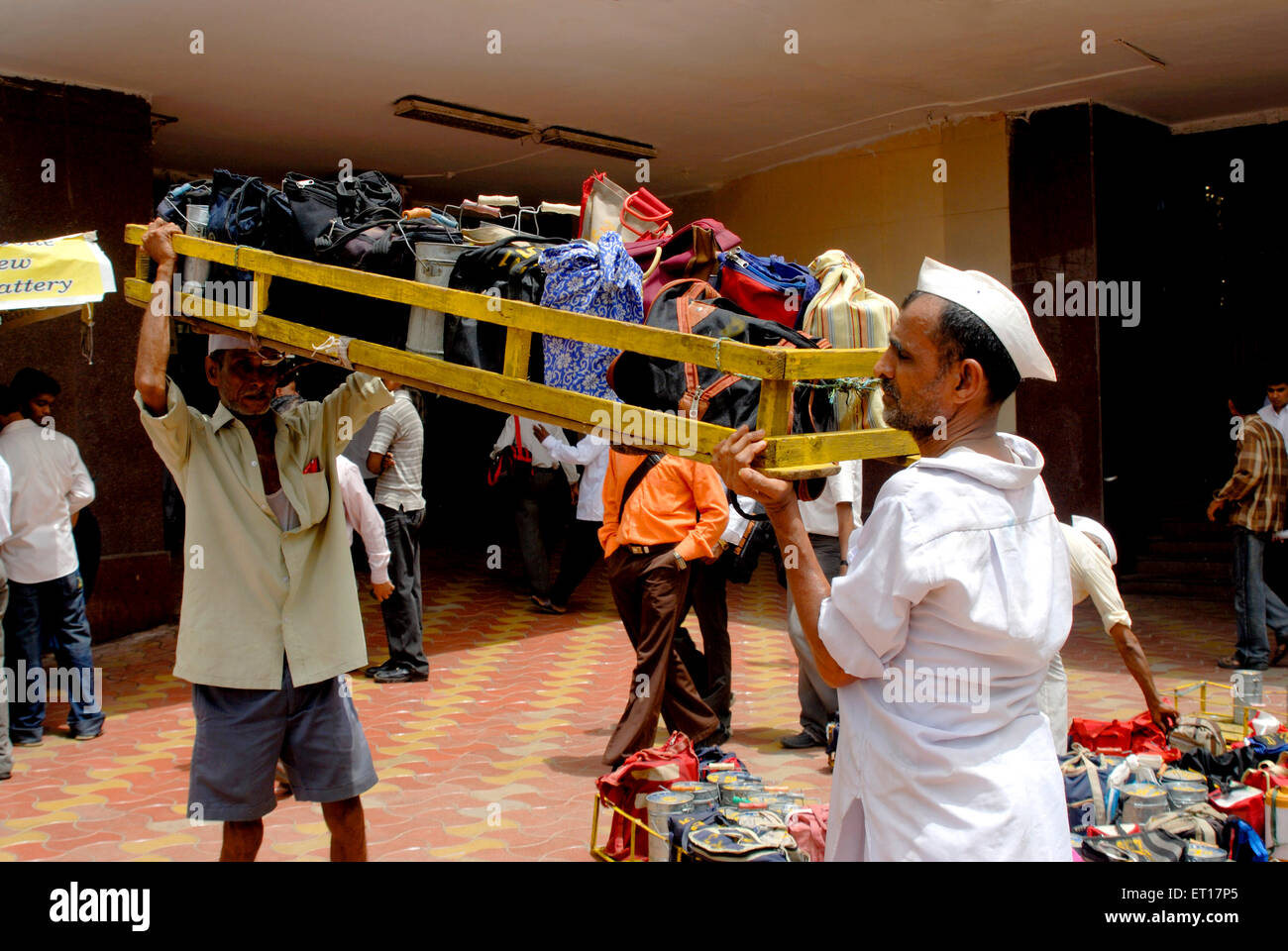 Tiffinwala dabbawala deliveryman carrying lunch boxes ; Bombay ; Mumbai ; Maharashtra ; India ; Asia Stock Photo