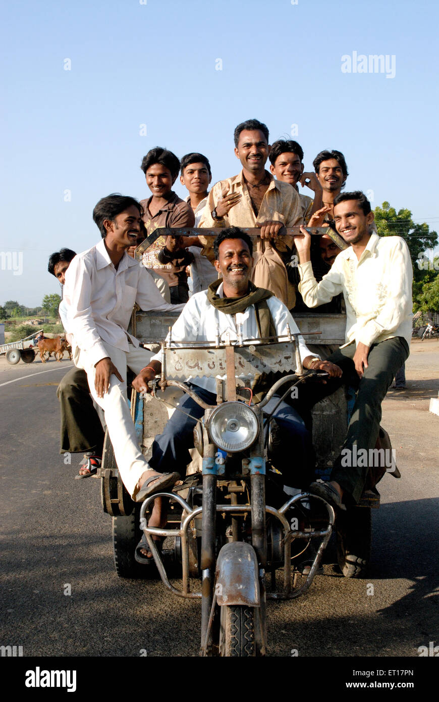 Men travelling on vehicle ; Amreli ; Gujarat ; India MR#364 Stock Photo