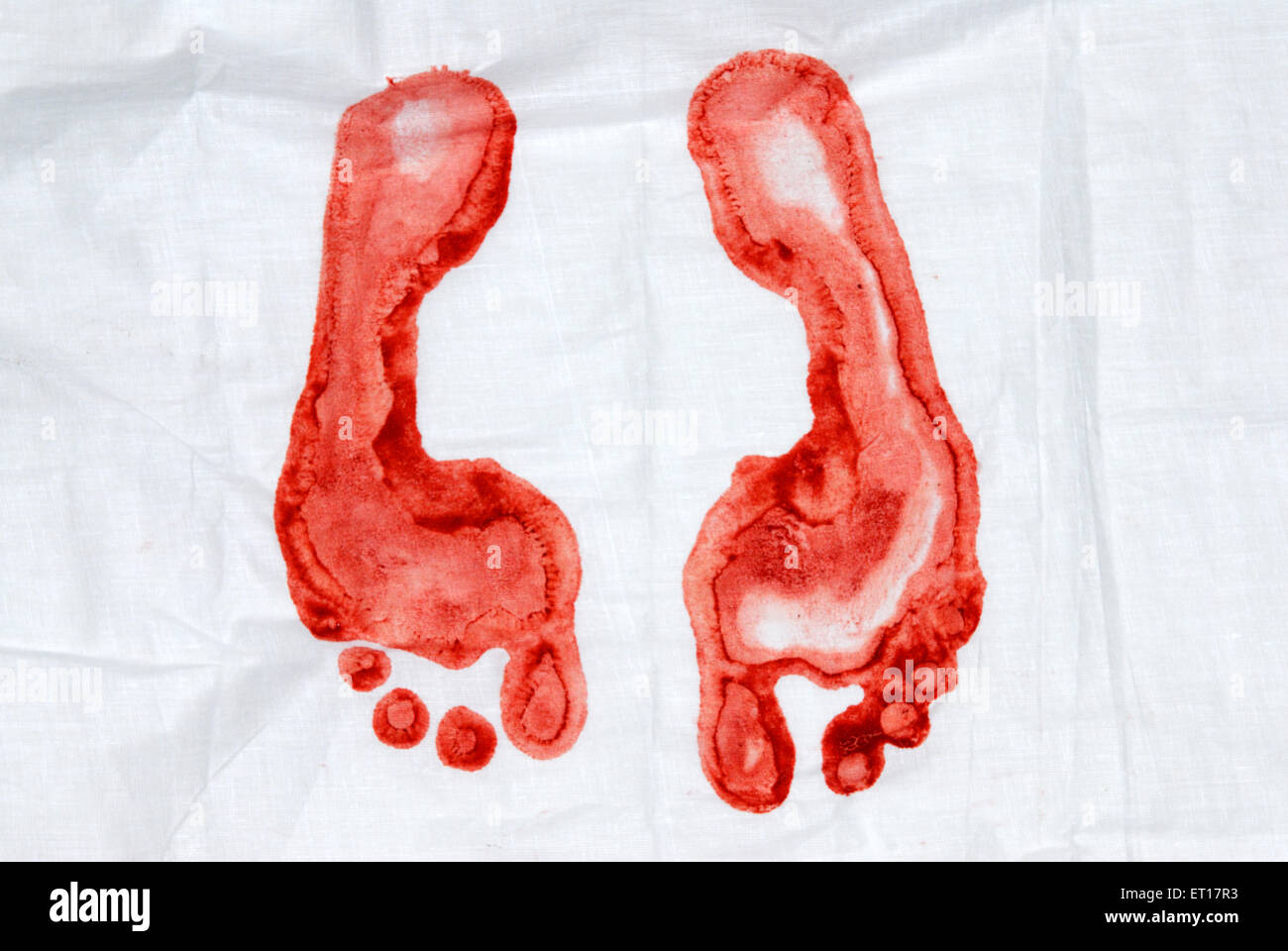 Foot print footprint with red kumkuma powder on white cloth Stock Photo