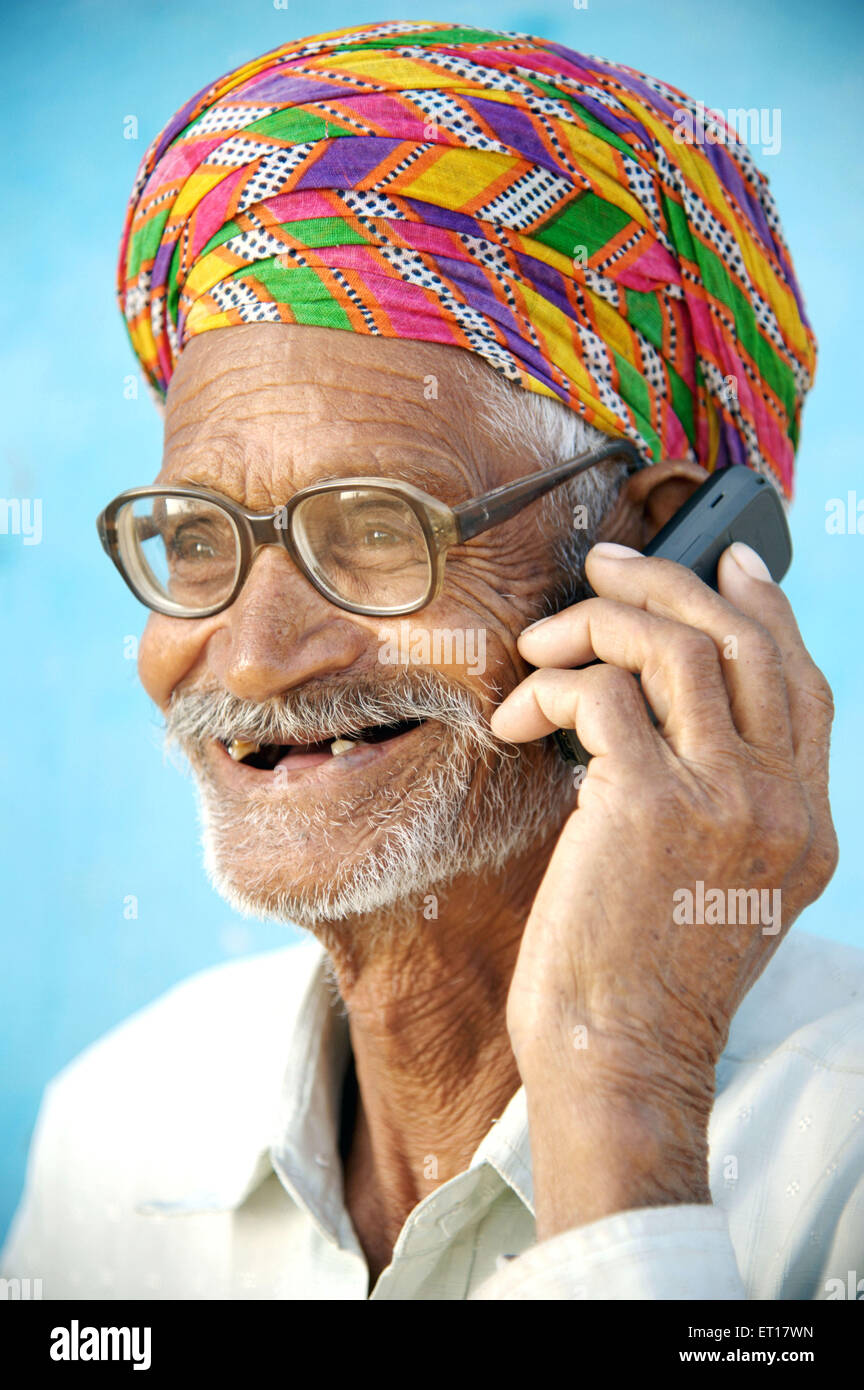 Indian old rural man turban glasses talking on mobile phone - MR#784B - rmm 178266 Stock Photo