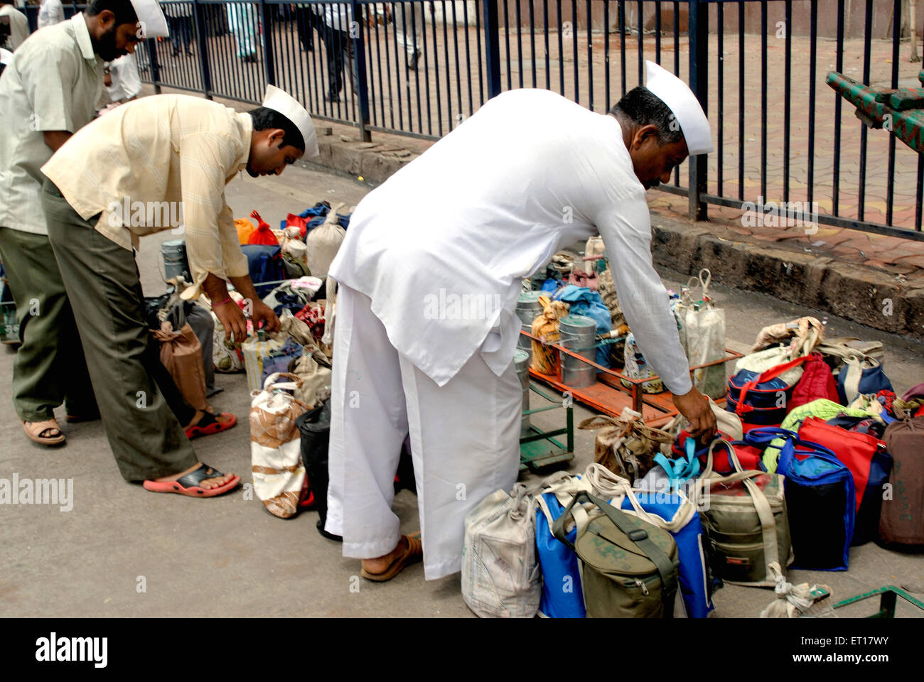 Tiffinwala dabbawala deliveryman carrying lunch boxes ; Bombay ; Mumbai ; Maharashtra ; India ; Asia Stock Photo