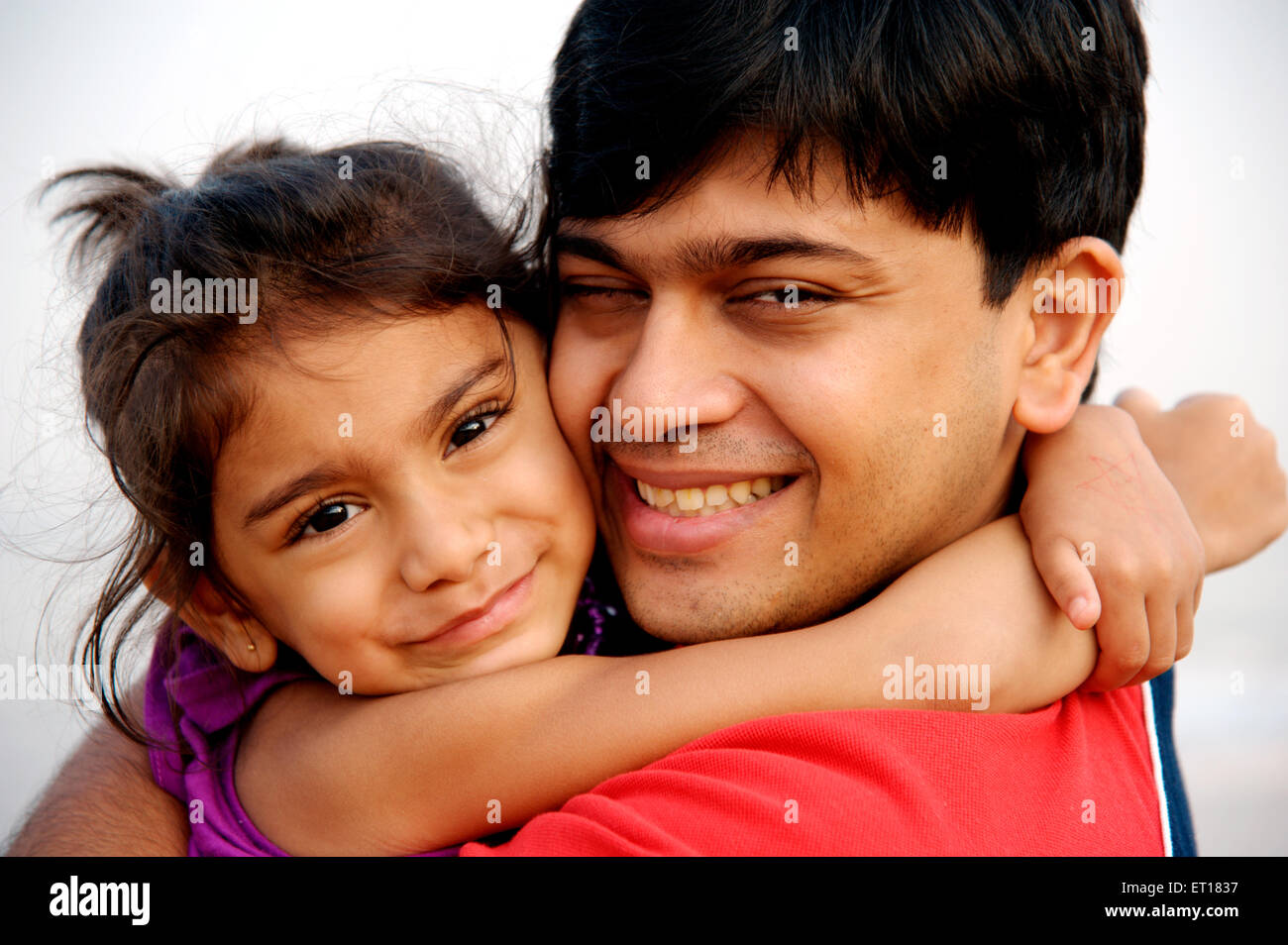 Daughter hugging father MR#736J&L Stock Photo