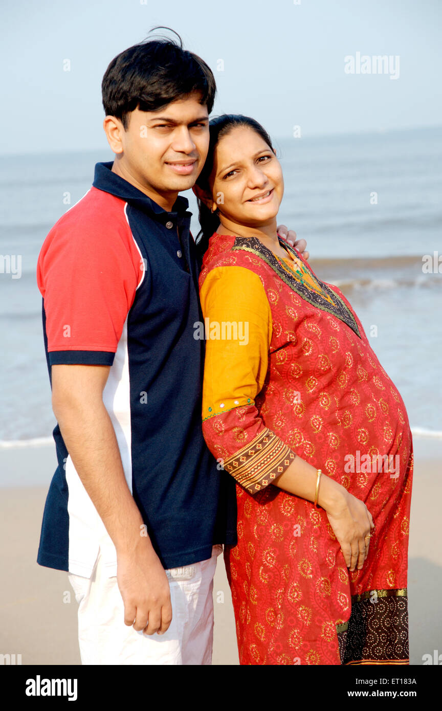 Indian young adult couple husband wife pregnant on beach - MR#736J ...