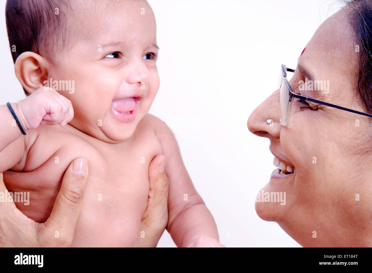 Indian mother woman playing with daughter baby child India MR#736LA&364 Stock Photo