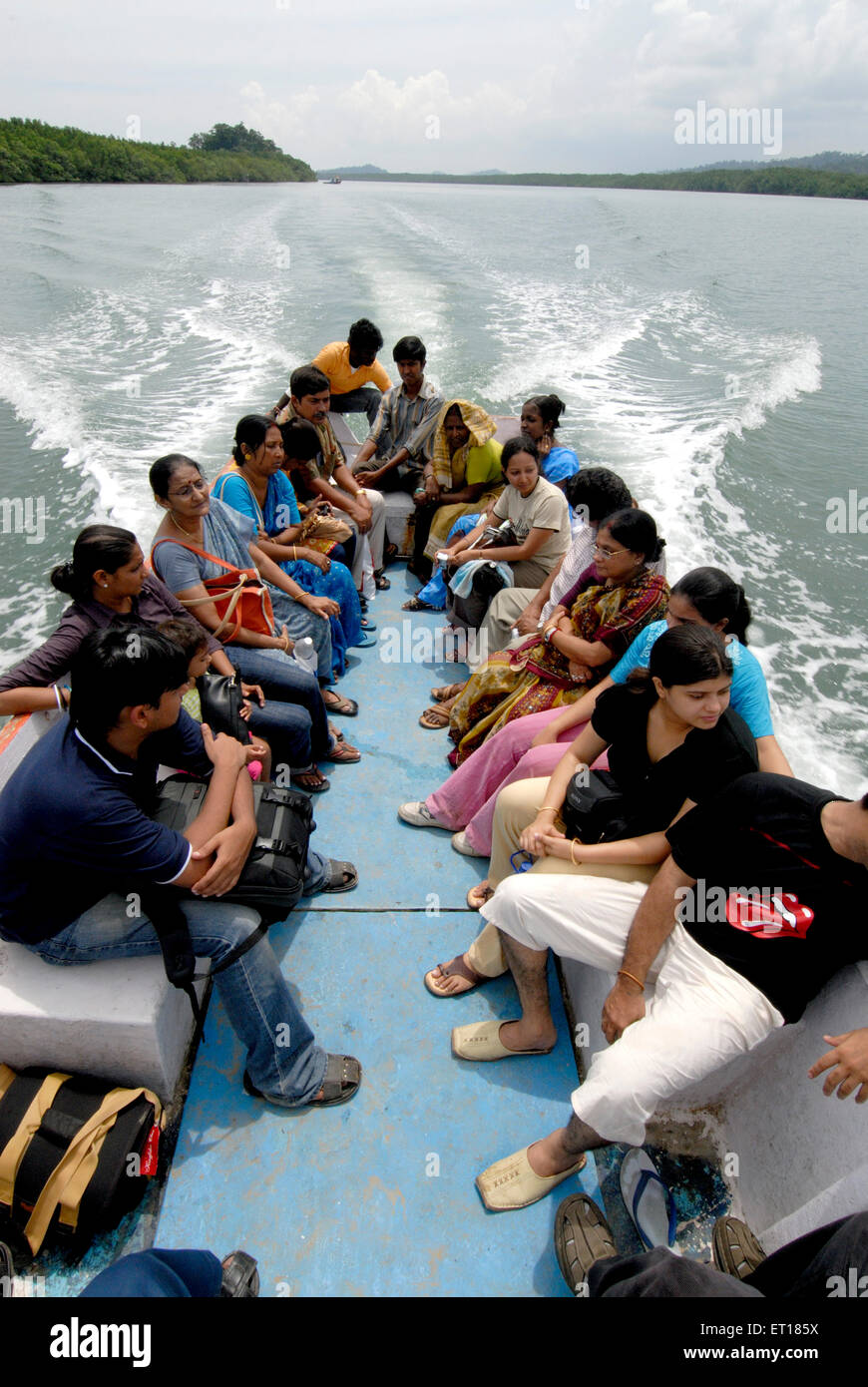Visitors travelling in small boat ; Andaman Islands ; Bay of Bengal ; India Stock Photo