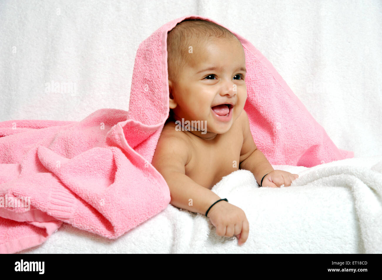 baby under pink towel on white background MR#736LA Stock Photo