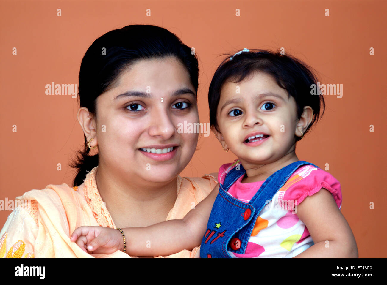 Mother and baby child portrait brown background MR#364 Stock Photo