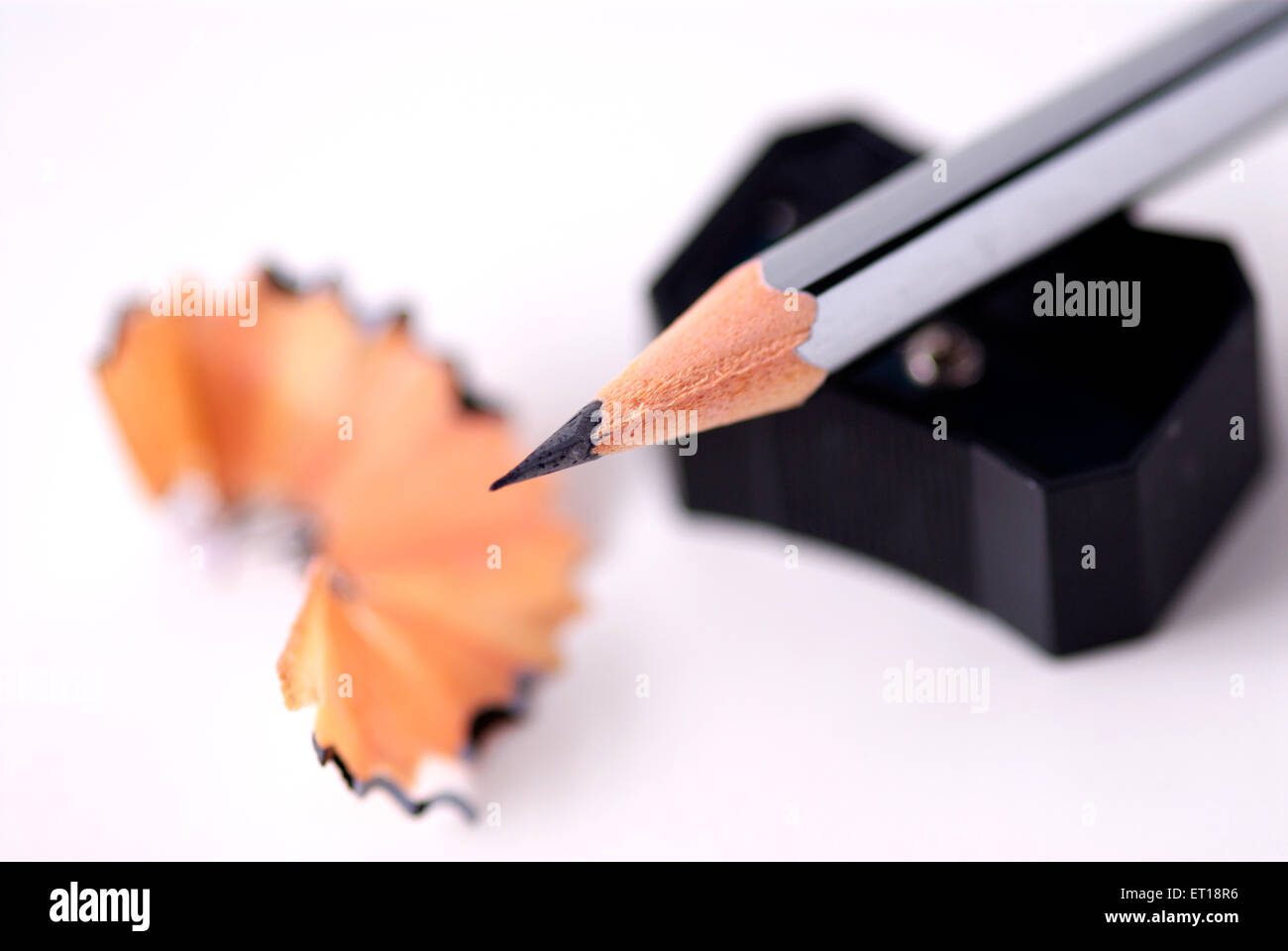Pencil with sharpener and shaving on white background Stock Photo