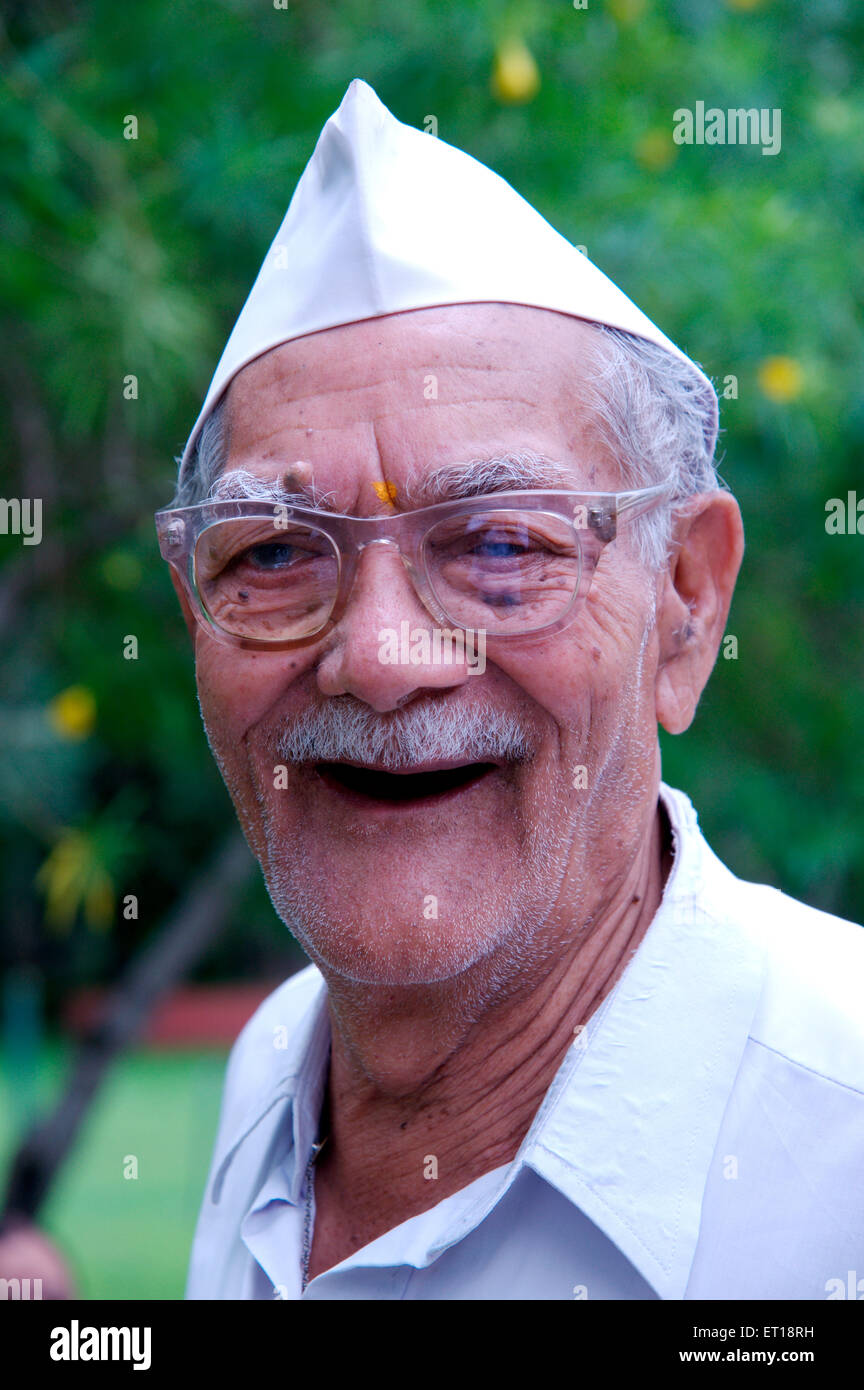 Old man laughing wearing Gandhi cap glasses mustache India MR#784M Stock Photo