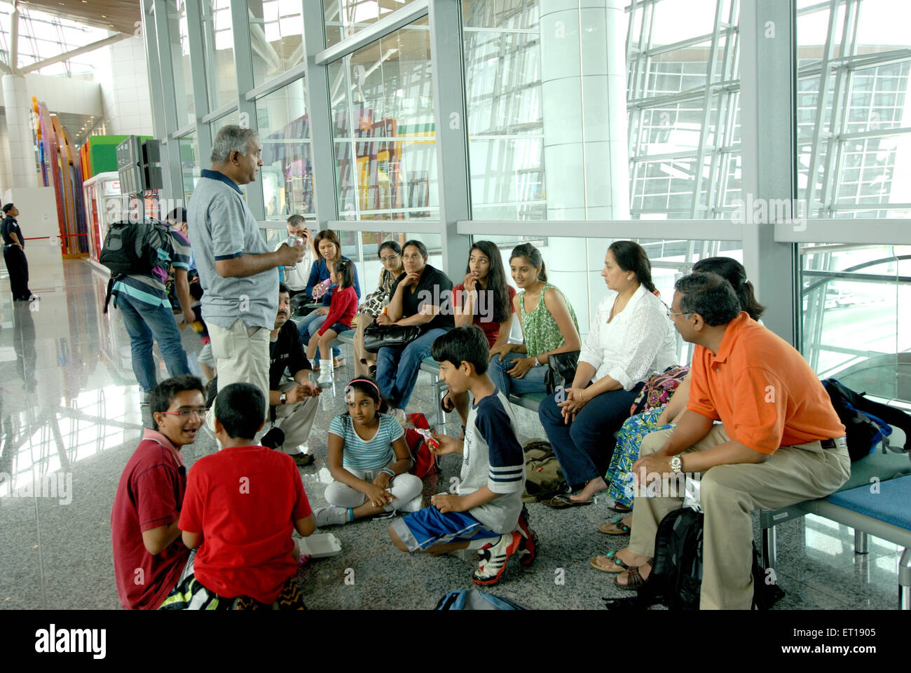 Indian family discussion Kuala Lumpur airport Malaysia - Model Release # 364 Stock Photo