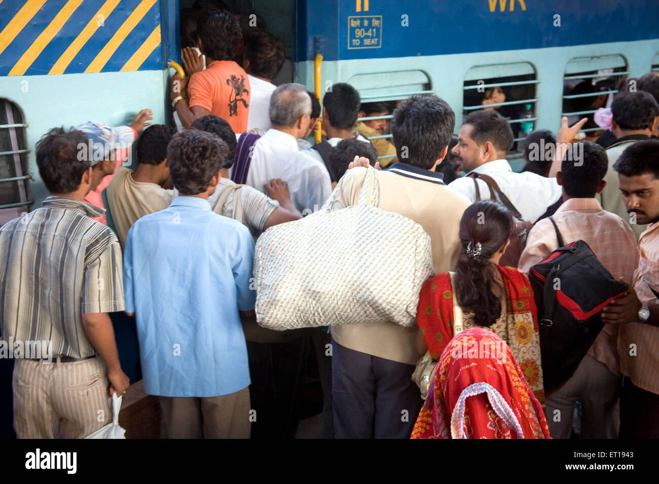 people trying to enter mail train at Borivali station Bombay Mumbai Maharashtra India Stock Photo