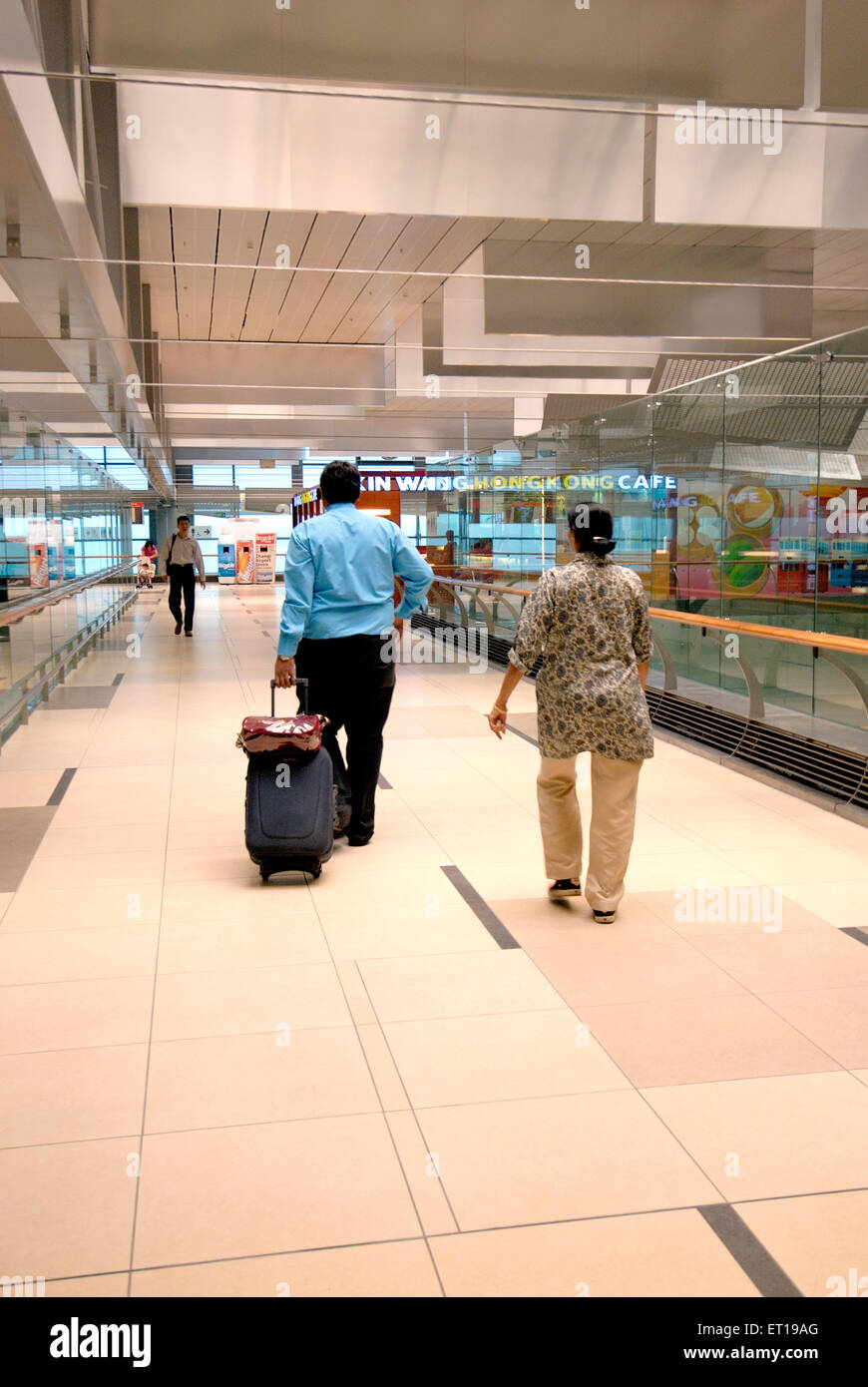 Tourists at airport terminal ; Singapore MR#364 Stock Photo