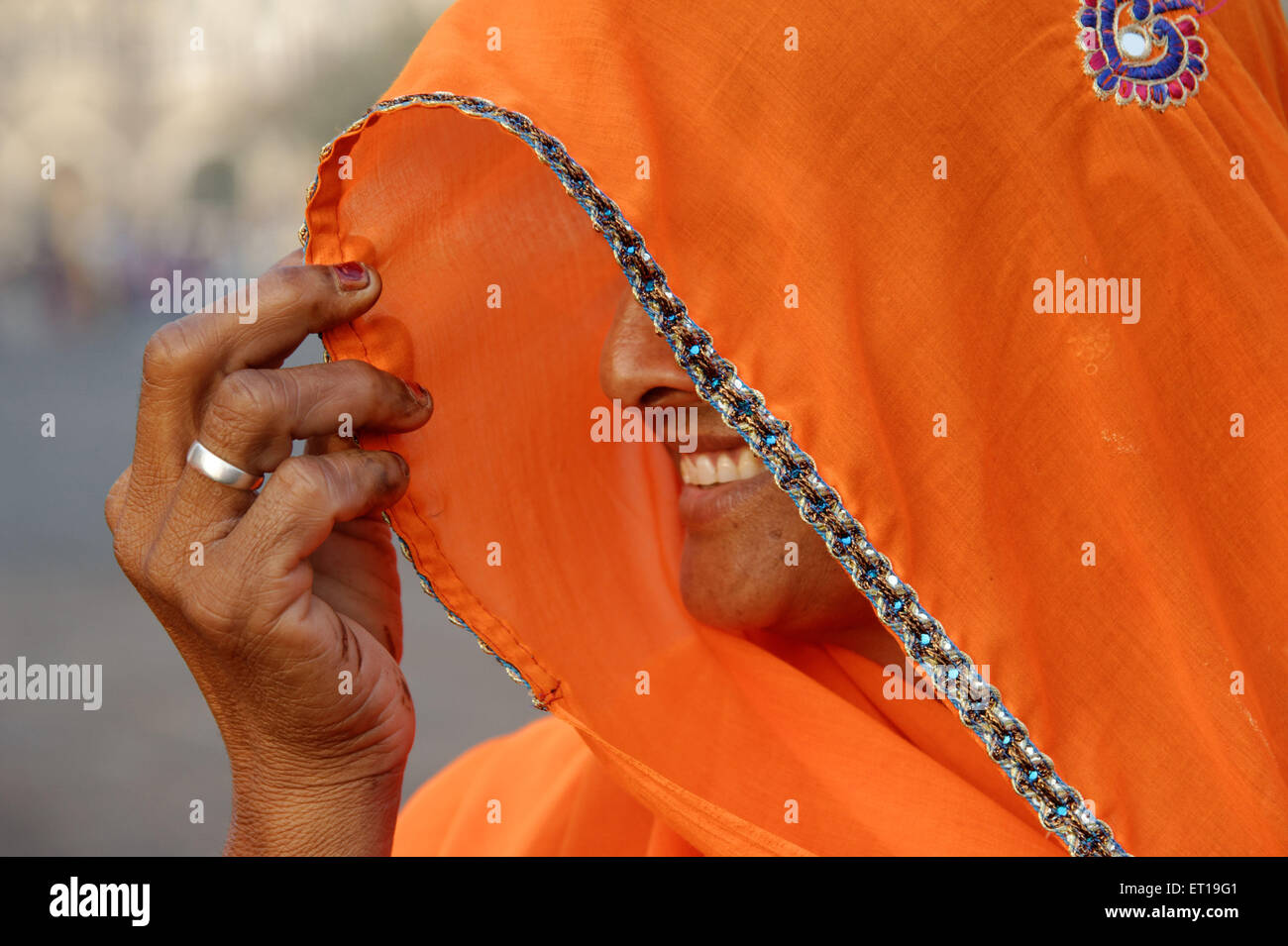Indian Hindu woman covering face with ghunghat India Asia - Model Release # 364 Stock Photo