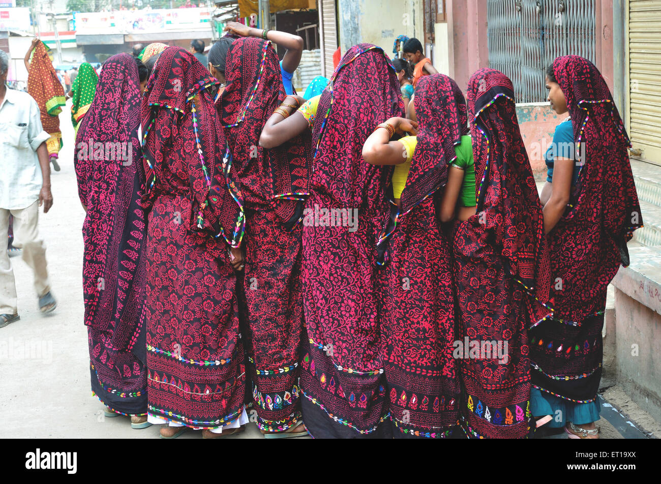 Tribal women in similar sarees in Kawant Gujarat India Stock Photo