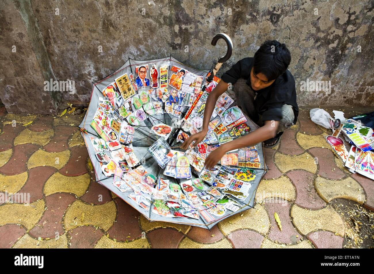 Innovative use of umbrella to display and sell colourful stickers Bombay Mumbai Maharashtra India Stock Photo