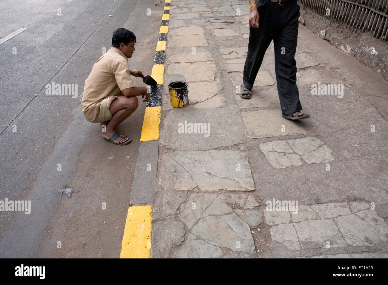 Man painting pavement curb stone in black and yellow ; Bombay Mumbai Stock Photo 83623069 Alamy