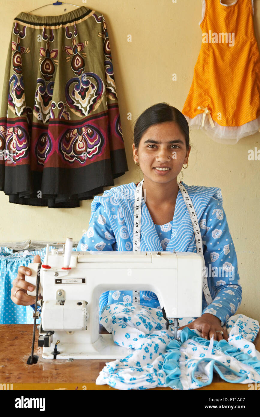 Rural girl on sewing machine socio economic initiative started by NGO