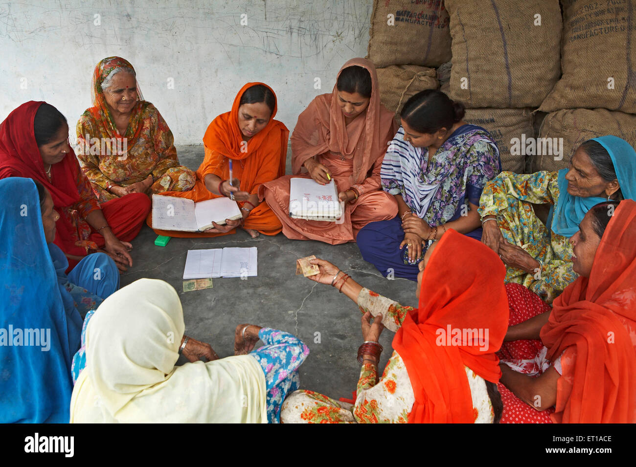Women volunteers of NGO Chinmaya Organization of Rural Development CORD collecting contribution from members Stock Photo