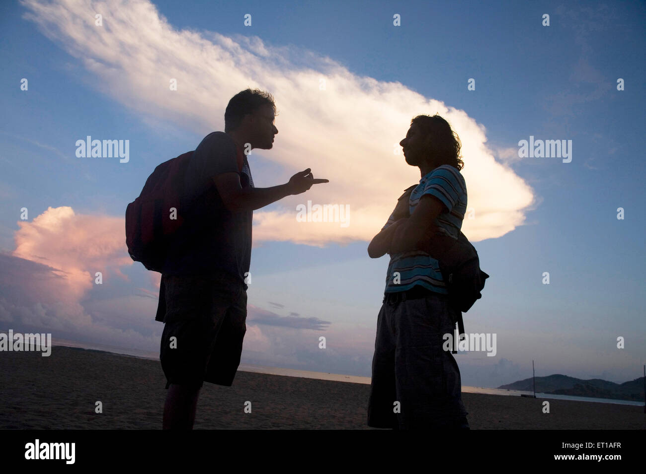 Couple talking ; Palolem beach ; Goa ; India Stock Photo