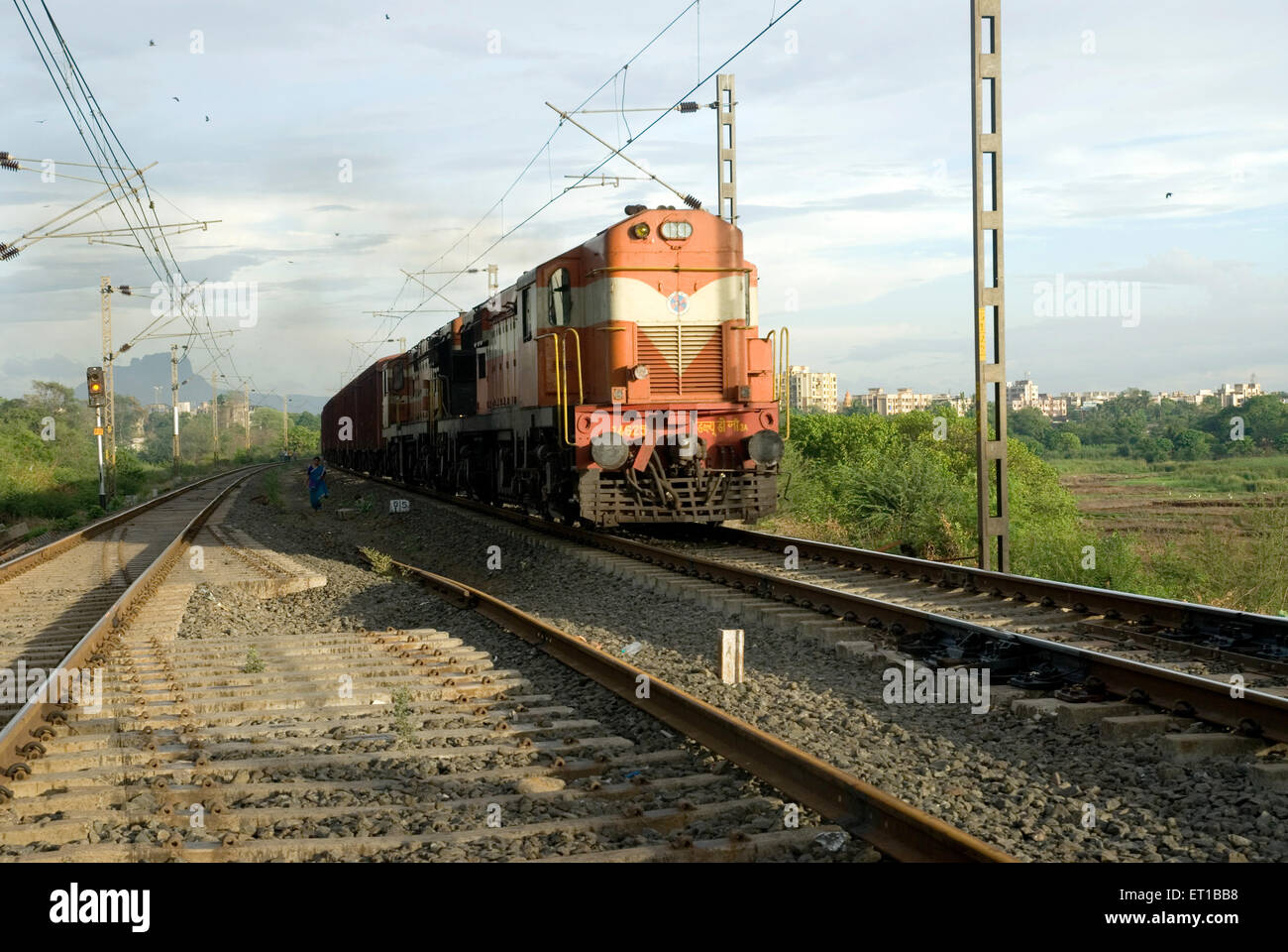 Goods train diesel engine running on electricity railway track ; India Stock Photo