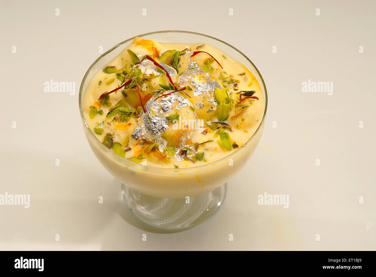 Sweet ; bengali mithai rasmalai served in glass on white background ; Jodhpur ; Rajasthan ; India Stock Photo