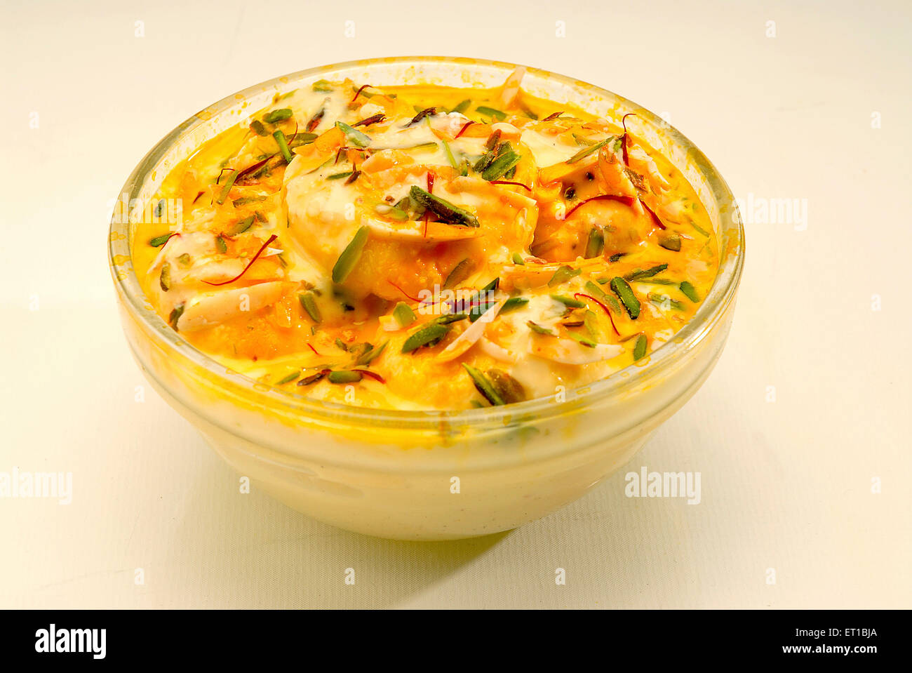 Sweet ; bengali mithai rasmalai served in glass on white background ; Jodhpur ; Rajasthan ; India Stock Photo