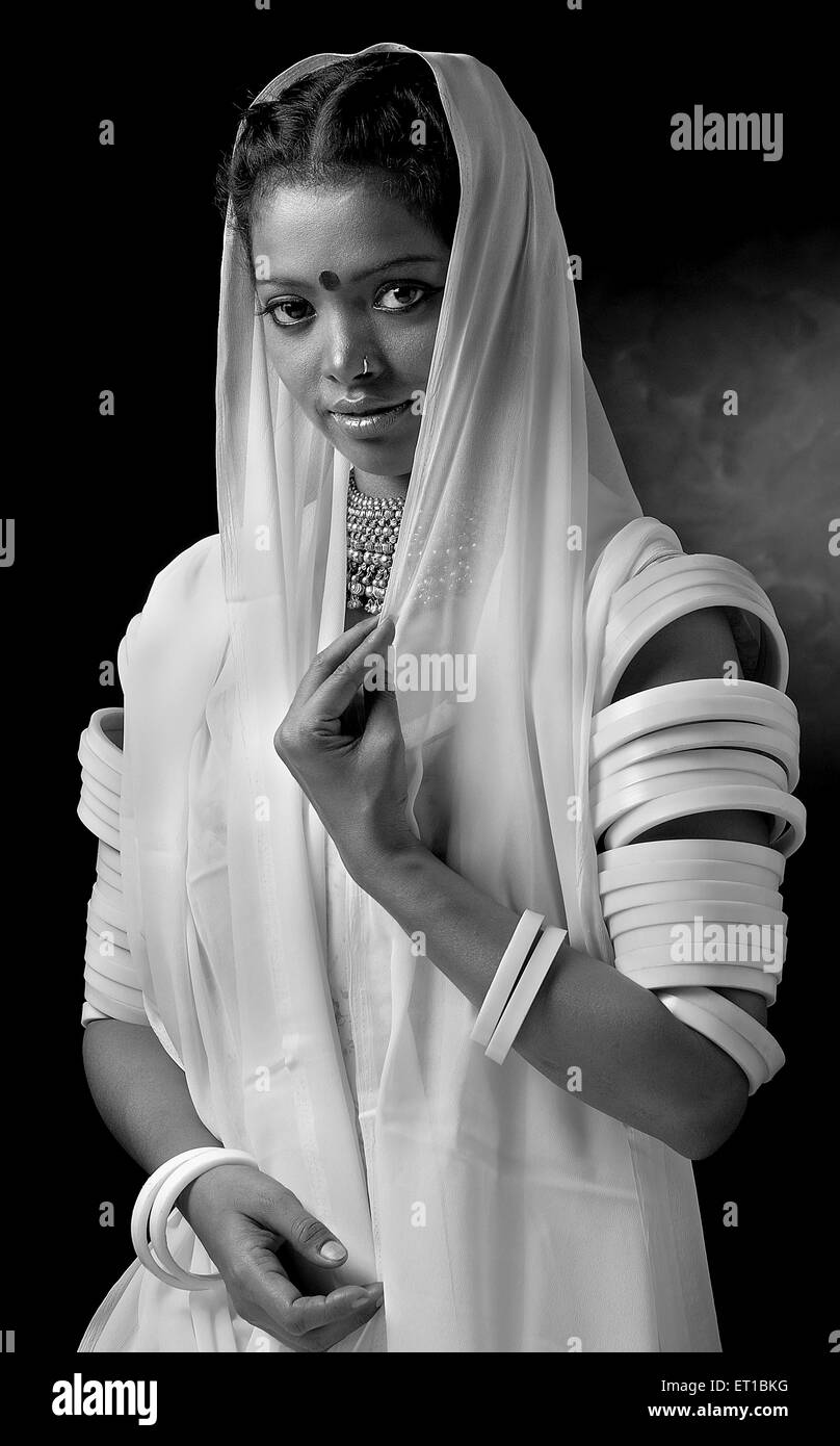 Woman in white dress, bangles in both hand , Jodhpur , Rajasthan , India - MR#746B Stock Photo
