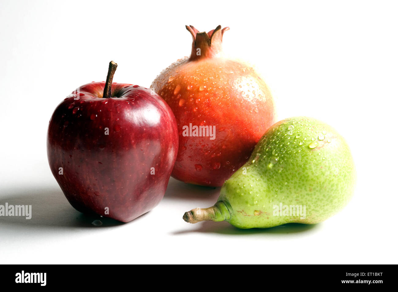 Fruits  ; water drops on apple ; pomegranate and pear on white background Stock Photo