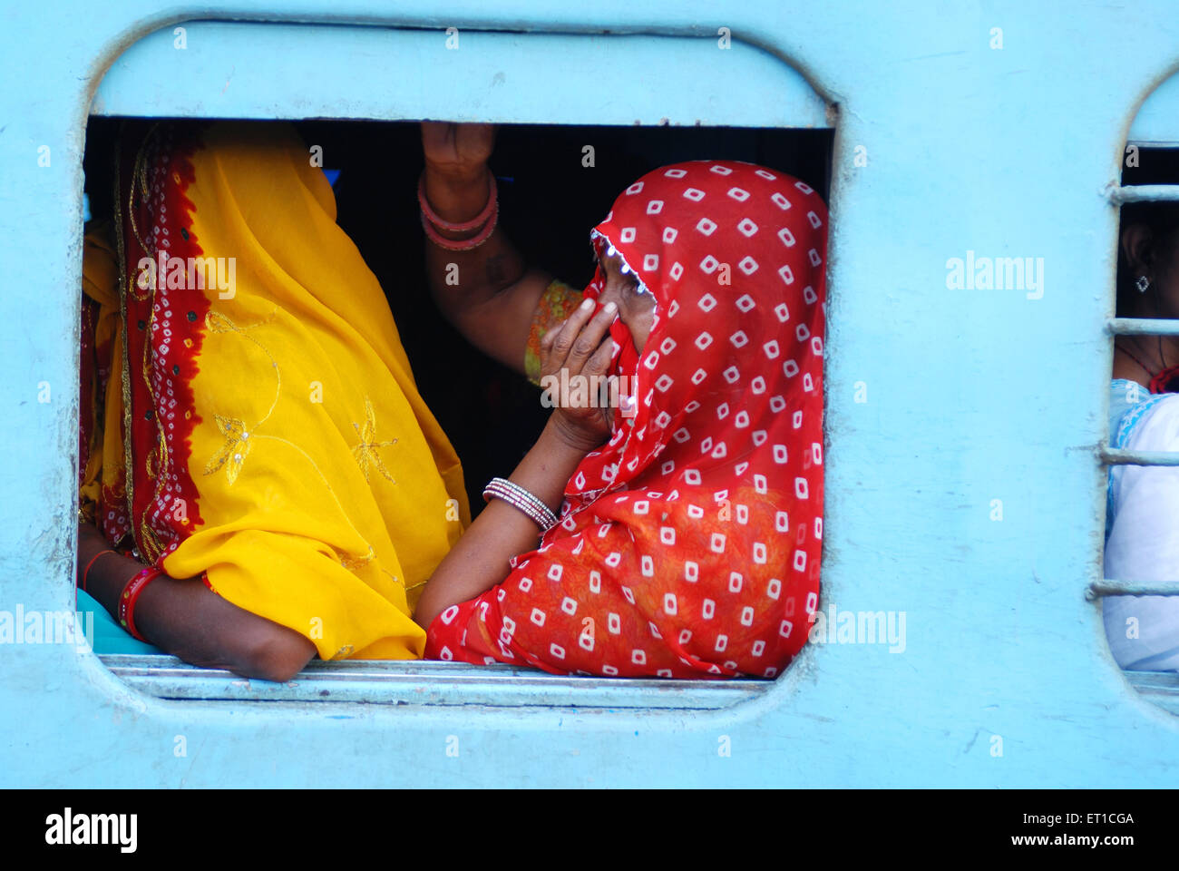 Rural women in window of train one looking outside ; Jodhpur ; Rajasthan ; India Stock Photo