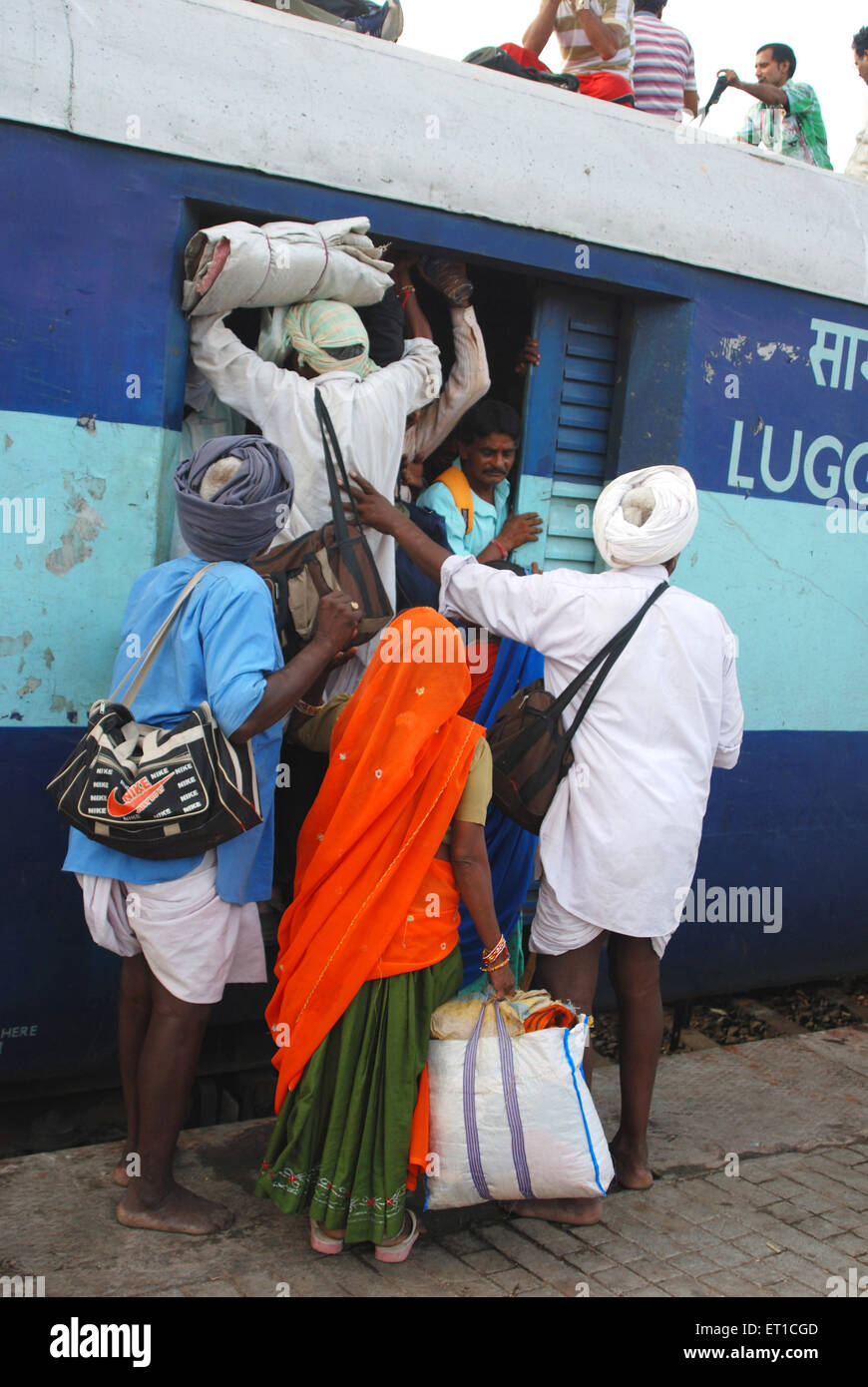 Commuters trying to board in luggage coach in train ; Jodhpur ; Rajasthan ; India Stock Photo