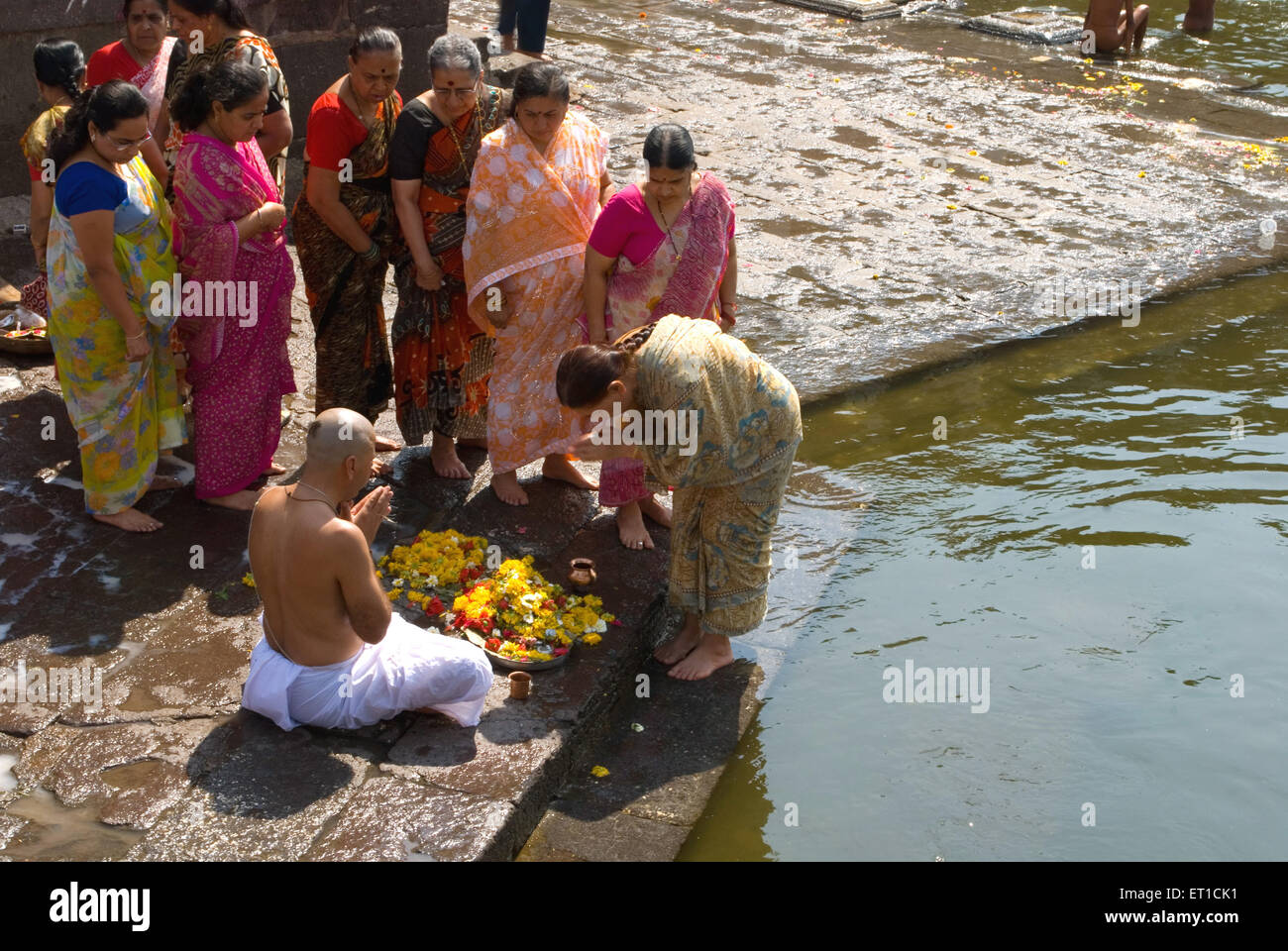 Hindu ritual near river, India, man praying ceremony for departed souls Stock Photo