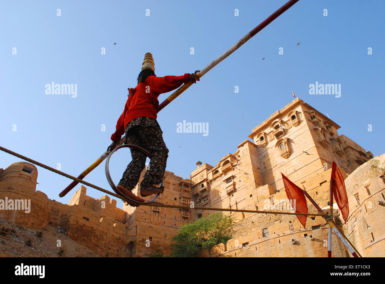 Girl performing acrobat on rope ; Jaisalmer ; Rajasthan ; India NOMR Stock Photo