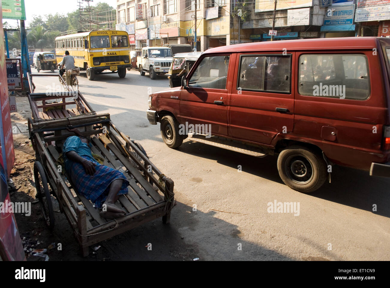 Man sleeping in handcart ; Guwahati ; Assam ; India Stock Photo