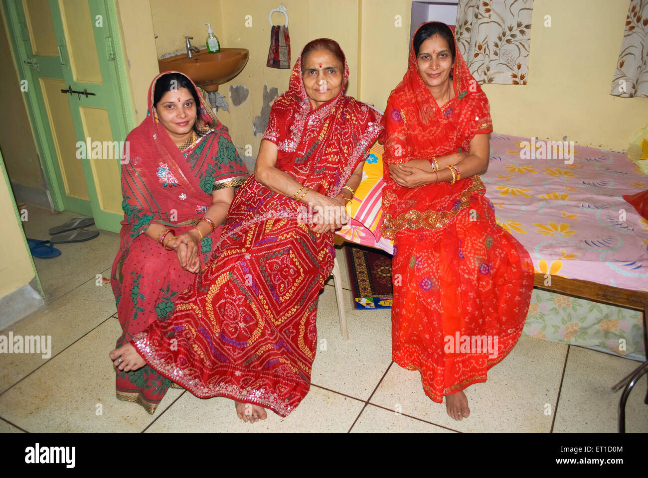 Mother in law flanked by two daughter in law in a home ; Jodhpur ; Rajasthan ; India NOMR Stock Photo