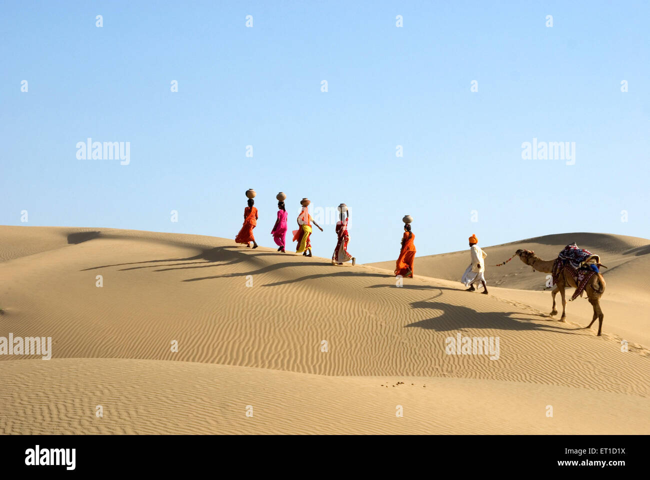 Men and woman with camel walking on desert Jaisalmer Rajasthan India - MR#704 - shi 176993 Stock Photo