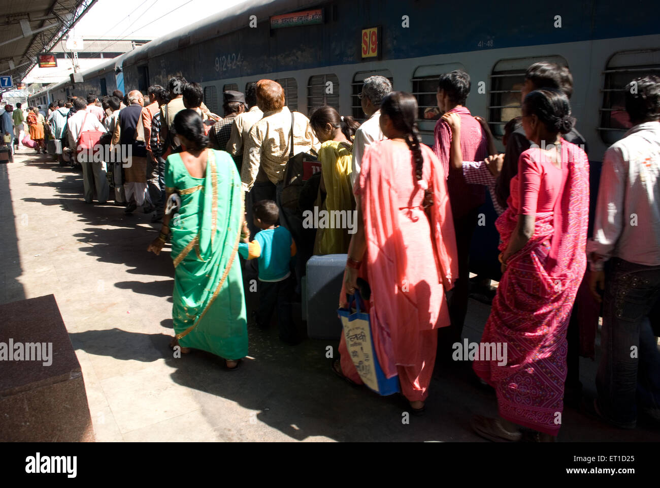 Travellers in queue to board a train on railway station ; Ahmedabad ; Gujarat ; India Stock Photo
