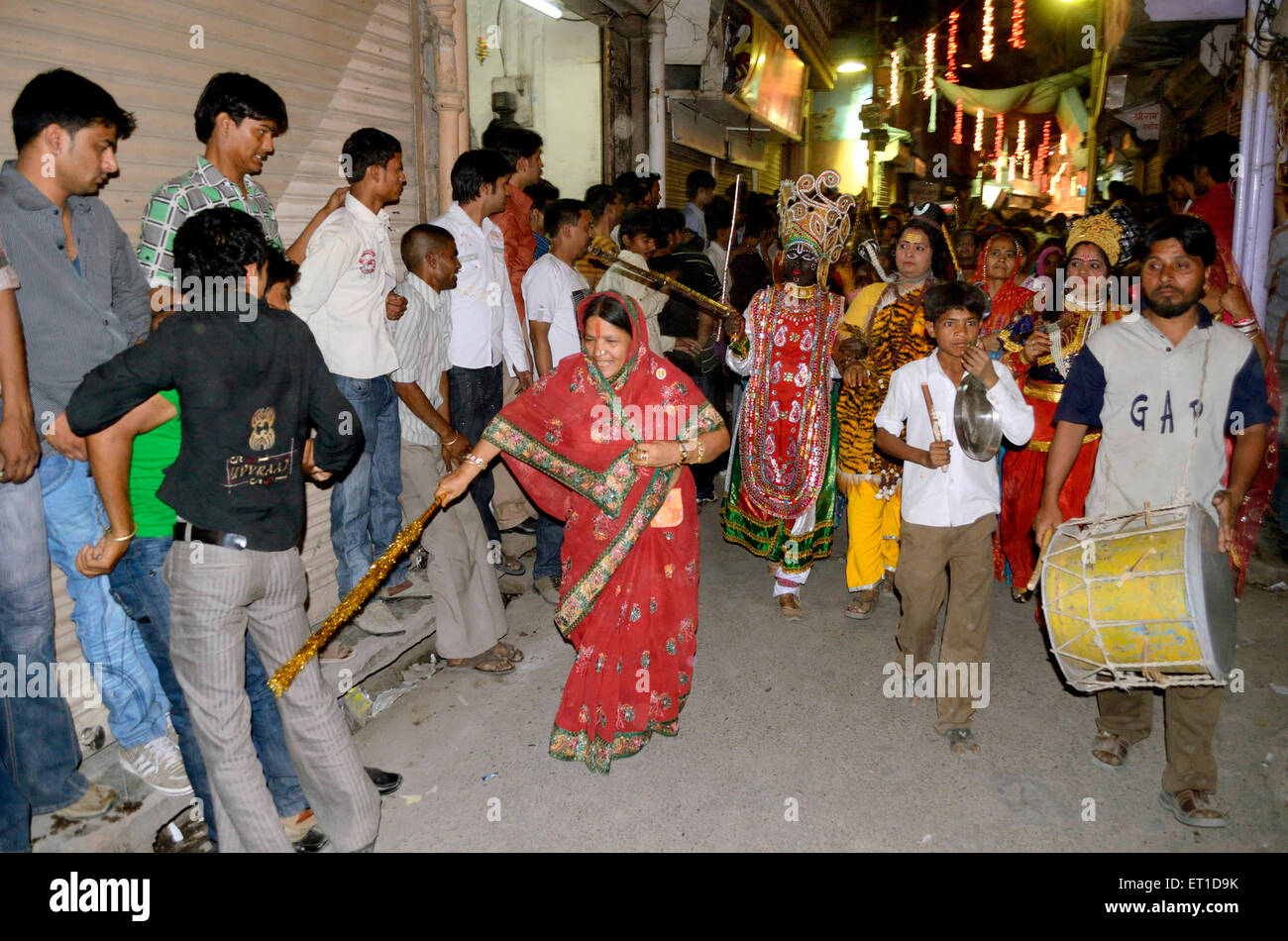 woman beating lightly boys stick women disguise back occasion of Dheenga Gavar festival Jodhpur Rajasthan India NO MR Stock Photo