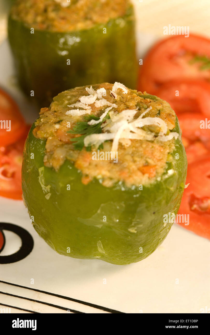 Stuff capsicum garnish with coriander leaves and grated coconut Stock Photo